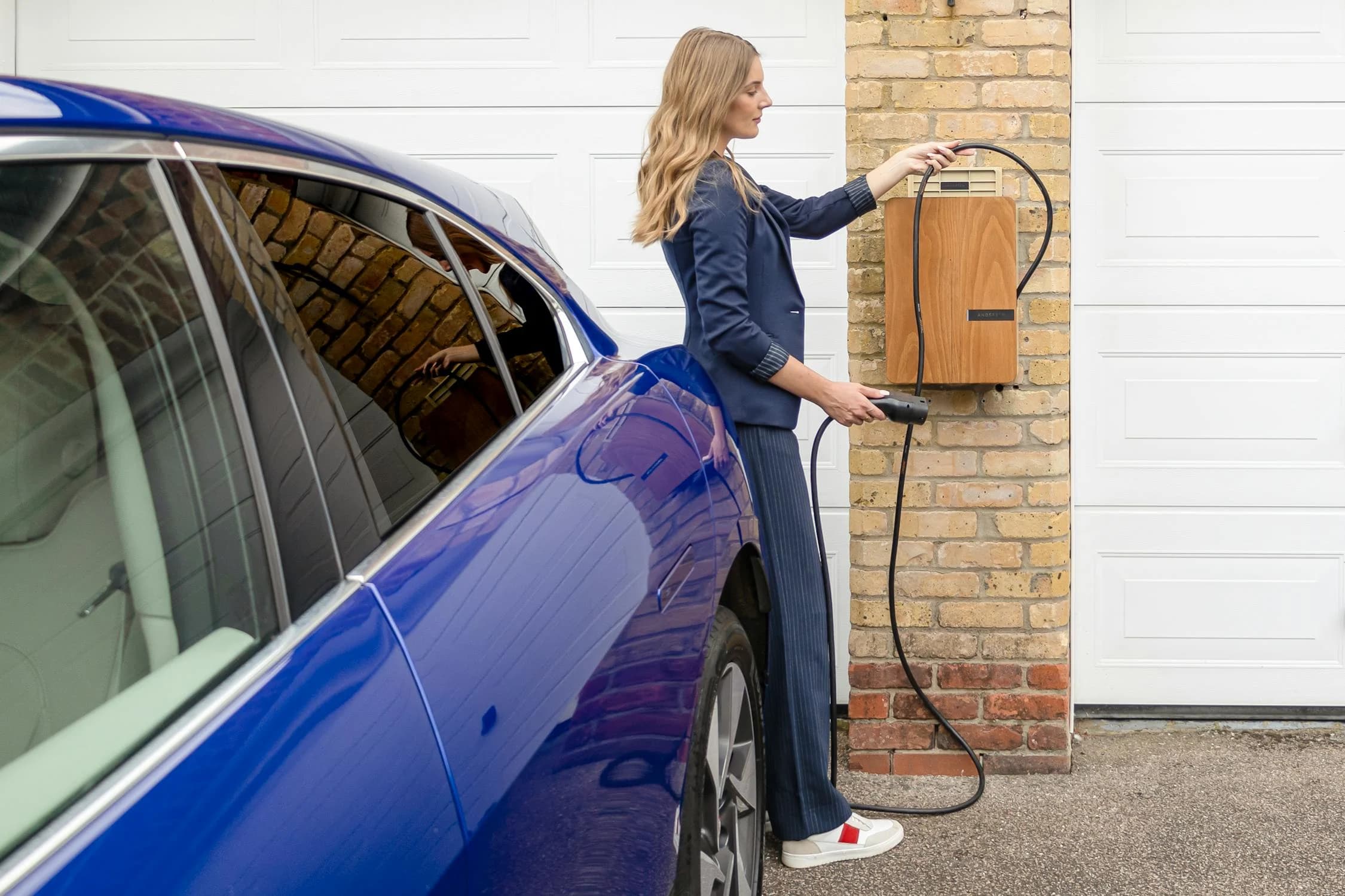 Modern EV charger installed on a brick wall